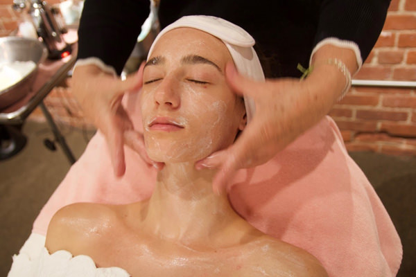 woman giving a facial in a spa
